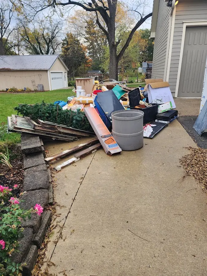 Dumpster being loaded with debris for 12 Yard Dumpster Rental in Herkimer